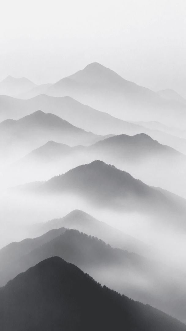 Misty mountain ridges in grayscale nature wallpaper