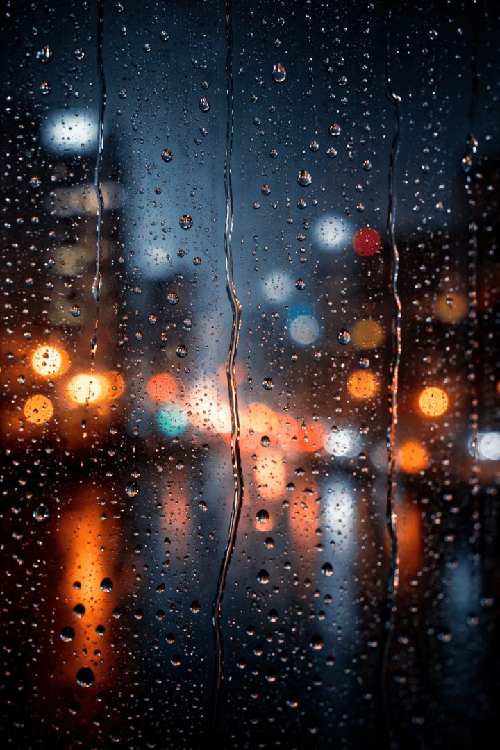 Rain Drops on Window with Blurred City Lights – Cozy Rainy Night 4K Wallpaper rain wallpaper