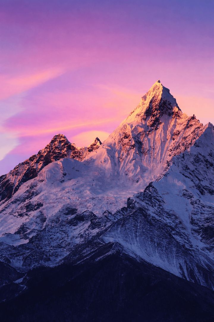 Snow-capped peak at sunset glow nature wallpaper